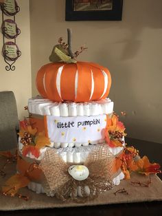 a three tiered pumpkin themed diaper cake