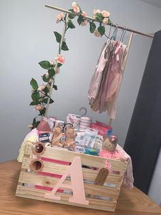 a wooden crate filled with baby items on top of a table