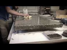 a man is making something out of concrete