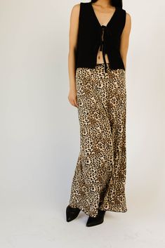 add a feisty touch to any outfit with this jaw-dropping leopard maxi skirt. guaranteed to turn heads, it has a silky, fitted silhouette with a stretchy elastic waistband. the perfect leopard printed skirt to dress up or down, season after season. leopard // maxi length, elastic waistband, scallop trim waist detail, bow detail paired with our good graces vest // black model is 5'8" + wearing a small measurements are approximate + taken while laying flat small : waist 26” length 37.5” medium : wai Wide Leg Maxi Skirt For Fall Day Out, Maxi Length Bottoms With Elastic Waistband For Fall, Fall Maxi Length Bottoms With Elastic Waistband, Fall Wide Leg Maxi Skirt With Elastic Waistband, Fall Maxi Skirt With Elastic Waistband And Wide Leg, Leopard Maxi Skirts, Leopard Print Skirt, Printed Skirts, Leopard Print