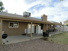 a small house with a grill on the roof