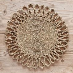 a round woven placemat on a wooden surface