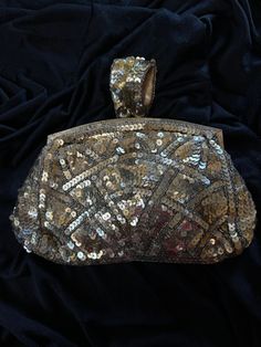 A very elegant 1930s evening purse made of gold coloured sequins. The interior is silk lined and has the initials MB. France Paris. The purse has a small centre handle for your fingers to go through  The gold tone on the  kiss lock and frame has worn but otherwise in excellent condition  Measures  7.5" x 4.5" Antique Style Evening Clutch Bag, Rectangular Evening Clutch With Sequins, Rectangular Sequin Clutch For Evening, Elegant Gold Bags With Sequins, Elegant Gold Sequined Bags, Vintage Handheld Evening Bag For Party, Luxury Gold Clutch With Sequins, Gold Sequined Evening Bag For Parties, Luxury Gold Sequin Clutch