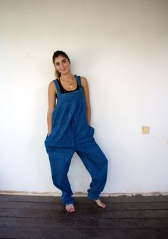 "Vintage Yessica at C & A blue denim overalls, high waist with a cord for cinching, oversized fit, green plastic buckle, adjustable straps, two large side pockets, adorn red, blue, and green stitches on the left pocket. aside from minor signs of wear, good vintage condition clean, and ready to wear. **Model is 5'7\" and size S for reference.**   Approximate size: One size fits most - Tag size: 44 - Please refer to the measurements M E A S U R E M E N T S -were taken with garments laying flat, pl Blue Relaxed Fit Denim Shortalls, Casual Blue Full-length Overalls, Casual Full Length Blue Overalls, Blue Denim Overalls With Relaxed Fit, Relaxed Fit Blue Denim Overalls, High Waist Blue Cotton Overalls, Blue Full-length Cotton Overalls, Full-length Blue Cotton Denim Jumpsuit, Blue Full-length Cotton Denim Jumpsuit