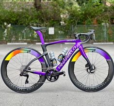 a purple bike parked on top of a parking lot