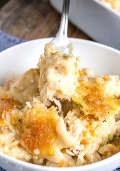 a close up of a bowl of food with a fork sticking out of the top