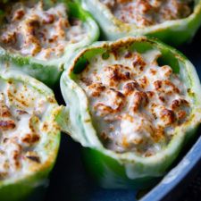 stuffed peppers with cheese and seasoning in a pan