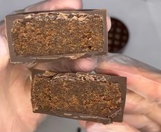 two pieces of chocolate are being held in their hands