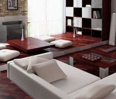 a modern living room with white furniture and wood flooring