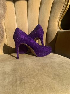 COLOR: This design is created in a darker purple glitter as shown with gold glitter soles. We are able to alter the color and or shade of glitter upon request. Please contact us for color changes.  STYLE: This is a closed toe high heel. If you would like an open toe, please leave a buyers note at checkout about the change.  HEEL HEIGHT: All of our heels come in three heel height ranges. Please select your height in the drop down menu below.  SHIPPING: We ship using 1-3 day priority mail within t Glitter Shoes Heels, Wedding Sneakers For Bride, Bling Wedding Shoes, Glitter Wedding Shoes, Glitter High Heels, Wedding Sneakers, Purple Heels, Custom Bling, Party Pumps