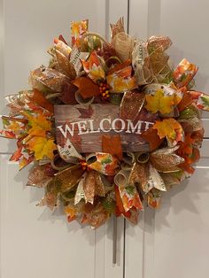 a welcome fall wreath hanging on the front door