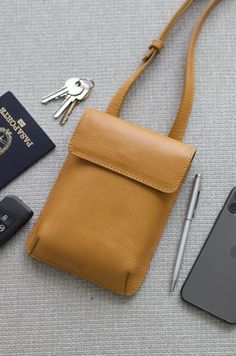 Vegetable tanned leather shoulder pouch. Funcional and compact design. The mini shoulder bag is a convenient way to carry around your essentials. It has enough space for a phone of any size, pen, passport, cards, keys and more. Front flap closure with magnetic snap. Inner money-card pocket and adjustable strap with buckle. Beige cotton lining.Handcrafted in Argentina by artisans in small batches, with every detail taken care of. Dust bag included for proper storage. Dimensions: - Height: 7”- Wid Crossbody Saddle Bag With Cell Phone Pocket For On-the-go, Everyday Pouch Satchel With Cell Phone Pocket, Travel Shoulder Bag With Cell Phone Pocket And Flap, Crossbody Phone Bag With Removable Pouch For Everyday, Everyday Crossbody Phone Bag With Removable Pouch, Travel Shoulder Bag With Mobile Phone Pocket, Modern Flap Shoulder Bag For Everyday Use, Rectangular Saddle Bag With Cell Phone Pocket, Travel Crossbody Flap Bag With Removable Pouch