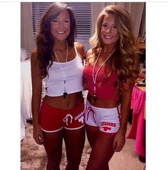 two beautiful young women standing next to each other in red and white shorts with the words dream written on them