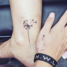 two people with matching tattoos on their feet, one has a dandelion tattoo