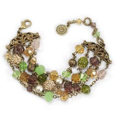 "The glow of a summer sunset is captured in the glistening crystal beads and earthy gemstones. Hold on to the feeling of relaxing, warm evenings on the patio--all day, and all year long. This bracelet features multi strands with beaded and crystal accents. An array of color fills the crystals for an attractive finish. Lobster claw clasp. Burnished bronze metal finish. - Green/Topaz option is shown in photos # 1, 4 and 5 - Rose/Gold option is shown in photos 2 and 3 Size: 7.5\" L + 2\" extender x Bohemian Crystal Beaded Bracelets, Bohemian Style Crystal Beaded Bracelets, Bohemian Beaded Crystal Bracelets, Bohemian Crystal Bracelet With Round Beads, Bohemian Crystal Beaded Bracelets For Jewelry Making, Bohemian Crystal Bracelet With Czech Glass Faceted Beads, Bohemian Czech Glass Crystal Bracelet With Faceted Beads, Bohemian Crystal Beaded Bracelet, Bohemian Czech Glass Beaded Crystal Bracelet