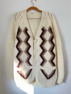 This chunky vintage cardigan is thickkk and soft. Perfect for fall! Size unmarked, fits like a L (great for oversized look too!). Vintage Knitted Sweater Coat For Fall, Vintage Knit Sweater Coat For Fall, Vintage Knitted Sweater Coat With Long Sleeves, Vintage Knitted Long Sleeve Sweater Coat, Retro Beige Cardigan For Winter, Retro Beige Winter Cardigan, Retro Knitted Cardigan For Fall, Retro Knitted Fall Cardigan, Vintage Fair Isle Pattern Outerwear For Fall