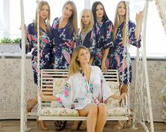 a group of women in robes sitting on a swing