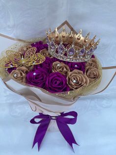 a bouquet of roses with a crown on top