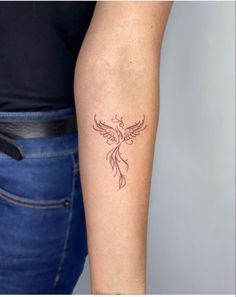 a woman's arm with a tattoo design on the left side of her arm