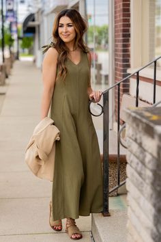 We love how this is such a great transitional piece going from season to season! The v cut neckline if modest and flattering and the relaxed leg bottoms make this jumpsuit suitable for any body type. Add a cardigan, blazer, or jacket for the cooler months and of course your favorite accessories to tie it all together! Casual V-neck Jumpsuits And Rompers In Solid Color, Fall V-neck Jumpsuits And Rompers In Solid Color, Relaxed Fit V-neck Jumpsuits And Rompers For Vacation, Chic V-neck Relaxed Fit Jumpsuits And Rompers, Casual V-neck Jumpsuit With Relaxed Fit, Solid Color V-neck Jumpsuit For Loungewear, Casual V-neck Jumpsuits And Rompers For Work, Solid Color V-neck Jumpsuits And Rompers For Spring, V-neck Solid Color Jumpsuits And Rompers For Spring