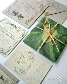 the wedding stationery is laid out on top of each other and tied with ribbon