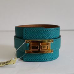 Condition: Nwt New Item With Tags; Never Worn. Excellent Condition Description: Herms Manchette Drag Veau Epsom Leather Bracelet Accentuated With Yellow Gold-Plated Hardware Line: N/A Material: Leather Width: Extra Wide Metallic Finish: Yellow Gold Plated Color: Ab Bleu Paon (Color Is Like A Jade) Size: T3 Herms Size: Circumference: Approximately 6.5" 16.5 Cm Inner Diameter: Approximately 2.4" Width: Approximately 1.6"" Herms: X 1d 011 Cf T3 Style Number: H072124ccabt3 Made In France All Items A Elegant Leather Bracelets With Gold-tone Hardware, Elegant Leather Bracelet With Gold-tone Hardware, Elegant Leather Bracelet With Gold-tone Hardware For Formal Occasions, Luxury Blue Cuff Jewelry, Luxury Leather Bracelet With Gold-tone Hardware, Luxury Leather Bracelet With Gold-tone Hardware For Formal Events, Luxury Leather Bracelet With Gold-tone Hardware For Formal Occasions, Luxury Blue Cuff Bracelet, Elegant Formal Leather Cuff Bracelet