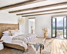 a large bed sitting inside of a bedroom on top of a wooden floor