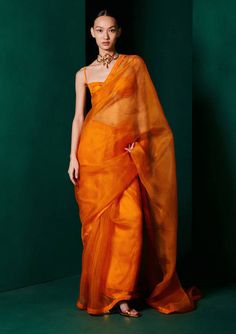 Luxury Orange Chanderi Blouse Piece, Luxury Orange Saree-style Blouse, Luxury Orange Lehenga In Saree Style, Luxury Orange Organza Traditional Wear, Luxury Orange Pre-draped Self Design Saree, Luxury Orange Saree For Festivals, Luxury Orange Saree With Unstitched Blouse, Luxury Orange Pre-draped Saree With Unstitched Blouse, Luxury Orange Blouse With Traditional Drape