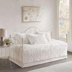 a white daybed in a bedroom next to a window