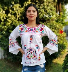 Well designed and well embroidery only for you. Mexican blouse embroidered flowers bell sleeve. This is a blouse embroidered by hand with beautiful colorful flowers. Very comfortable, Goes great with jeans, leggings, skirt, shorts... Each piece is unique and handmade with dedication and taking care of every detail achieving the best quality in our products, which is why it makes it beautiful and unique each of the embroidered flowers. More style, check the following link: https://www.etsy.com/mx Spring Motif Long Sleeve Blouse, Traditional White Peasant Top For Fall, Spring Long Sleeve Blouse With Motif, Spring Embroidered Long Sleeve Top With Motif, Long Sleeve Embroidered Top With Motif For Spring, Festive Long Sleeve Tops With Motifs, White Blouse With Embroidered Sleeves For Fall, Summer Embroidered Blouse With Bell Sleeves, Folk Style Embroidered White Top For Fall