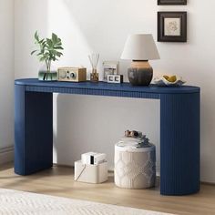 a blue console table with pictures on the wall