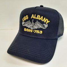 a navy blue hat with the words usss albany on it and two alligators