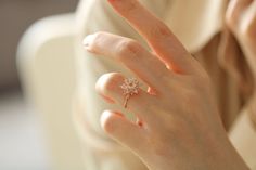 a woman's hand with a diamond ring on her finger, showing the middle finger