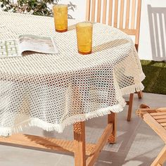 an outdoor table with two glasses on it