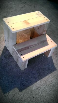 a wooden bench sitting on top of a carpeted floor