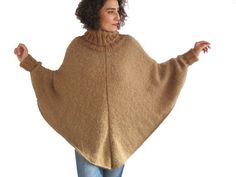 Hand Knitted Turtleneck Poncho Sweater Brown Knit Poncho For Winter, Brown Knit Winter Poncho, Cozy Knit Poncho, Winter Brown Knit Poncho, Cozy Turtleneck Poncho For Winter, Knitted Long Sleeve Cozy Poncho, Casual Chunky Knit Winter Poncho, Hand-knitted Beige Poncho For Winter, Hand Knitted Beige Poncho For Winter