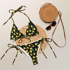 A Fresh and Zesty Summer Look Only Achievable in the Lemons Recycled String Bikini! Refresh your summer with string bikini vibes in Lemons – your vibrant choice for stylish summer dips. Made from soft recycled polyester with double-layering and UPF 50+, this All-Over Print set ensures a comfortable and refreshing experience. The bikini top, featuring removable padding, offers multiple ways to tie and style the straps. With sizes up to 6XL, this string bikini is the perfect choice for a chic and Beachwear Swimwear With Lemon Print For Beach, Summer Lemon Print Swimwear For Pool, Summer Swimwear With Lemon Print, Summer Lemon Print Beachwear Swimwear, Fitted Lemon Print Swimwear, Summer Swimwear, Summer Celebration, Summer Look, Swimwear Collection