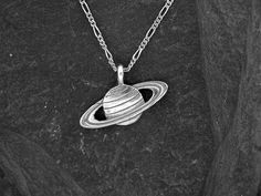 "This solid 3 Dimensional Saturn pendant is Sterling Silver. The included chain is a Sterling Silver Figaro 50 chain. You may choose 16, 18 or 20 inch at the same price. Other length available at sightly higher prices. This Saturn pendant measures1\" tall by 1 5/16\" across. I hand cast all my pieces using the lost wax casting method. Please ask your needs. You may call me with questions, often I am out so please use my machine. 831-476-3176. Satisfaction Guaranteed! I send items USPS First Clas Saturn Pendant, Saturn Necklace, Medieval Jewelry, Wax Casting, Lost Wax Casting, Image Comics, Outfits 2022, Lost Wax, Hand Cast