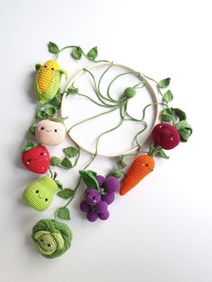 crocheted fruits and vegetables are arranged in a circle