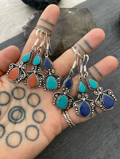 The perfect everyday light and comfy earrings with a unique double teardrop ethnic design. Made with alloy metal and a choice of 3 different mix of stones. They are made with Turquoise stone dust, Lapis stone dust and Coral stone dust, put together with resin. All have silver hooks. In one of the pictures you will see a number that represents the style for you to choose from. The earrings are 3.7cm- 1.30 inch long 1.7cm- 0.75 inch wide The drop length is 5cm- 2 inch. A unique addition to your ea Festival Teardrop Earrings With Ear Wire, Bohemian Teardrop Earrings With Matching Pair, Bohemian Hypoallergenic Drop Earrings, Bohemian Teardrop Earrings With Ear Wire, Teardrop Earrings For Festival, Bohemian Adjustable Hypoallergenic Teardrop Earrings, Bohemian Teardrop Long Drop Earrings, Bohemian Hypoallergenic Teardrop Dangle Earrings, Bohemian Long Drop Teardrop Earrings