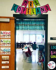 the entrance to mrs copeland's classroom is decorated with colorful letters and posters