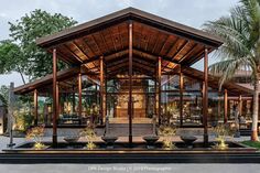 an outdoor pavilion with plants and potted trees