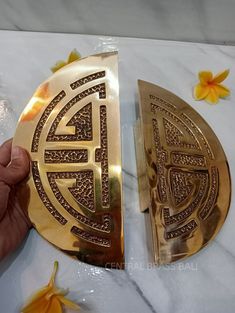 two gold plates sitting on top of a marble table