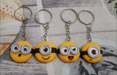 three minion key chains with eyes on them