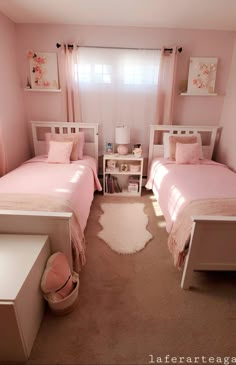 two twin beds in a bedroom with pink walls and carpeted flooring, one has a white rug on the floor