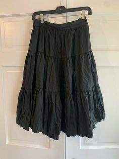 Vintage Rockmount Tru-West Ranch Wear Western Square Dance Black Cotton Skirt. Midi length and full style. Back zipper and part of the waist band is elastic. No size tag but the waist size (not stretched) is about 28 and it goes to 30”. So it’s about an 8-10. No issues just a tiny tear on the inside of the waistband lining. See photo. Thanks for looking:) Rock Style Lined Skirt, Vintage Black Long Skirt, Rock Style Cotton Skirt For Spring, Spring Cotton Rock Style Skirt, Vintage Tiered Skirt For Summer, Black Vintage Ruffled Skirt, Vintage Black Gathered Skirt, Rock Style Summer Skirt, Rock Style Skirt For Summer