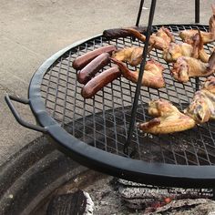 several sausages and hot dogs cooking on a grill