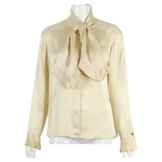 Vintage Chanel cream silk charmeuse blouse with knife pleated trim at the neckties and sleeve cuffs. Features hidden button closures down center front and goldtone CC logo buttons at the cuffs. No size tag - please consult measurements. Chanel Blouse, Boutique Blouse, Chanel Cream, Chanel Boutique, Knife Pleat, Color Crema, Cream Silk, Chanel Vintage, Silk Charmeuse