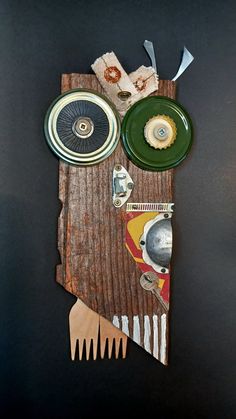 a piece of wood with plates and other items on it sitting on a black surface