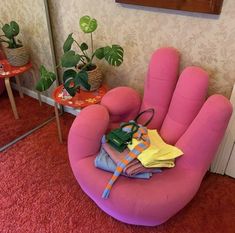 a pink chair sitting on top of a red carpet